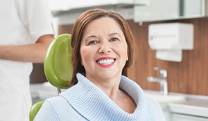 Lady sitting on dental chair smiling
