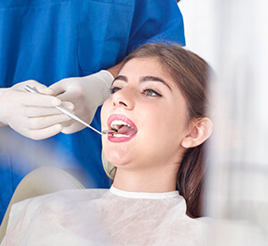 lady being examined with dental mirror
