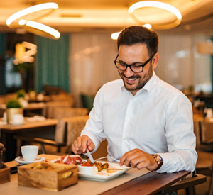 Man smiling while enjoying meal at restaurant