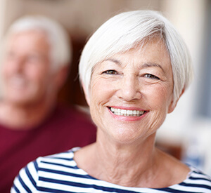 Elderly lady in striped shirt smiling