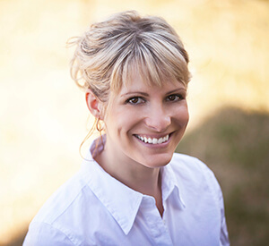 Richardson Endodontics lady in white button up smiling