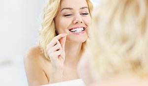 Woman flossing her teeth