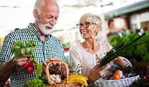 A happy senior couple buying fresh foods