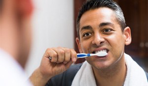 Man brushing his new dental implants in Richardson  