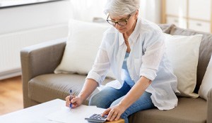 Woman reviewing her dental insurance coverage for dental implants in Richardson 