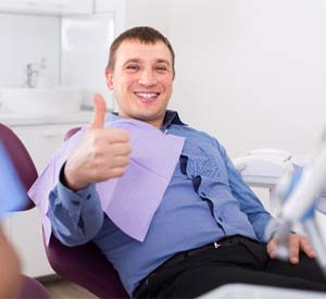 Dentist handing patient forms