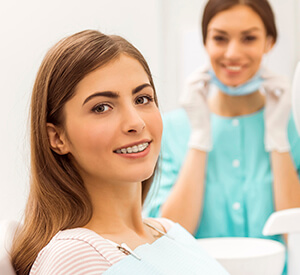 Female patient and dentist smiling