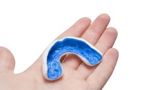 Mouthguard resting in person’s open hand