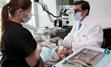 Dentist and assistant examining patient