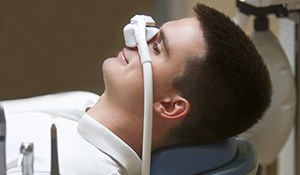 man with nitrous oxide mask placed over his nose 