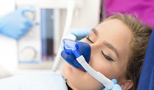 young woman with nitrous oxide mask over her nose 