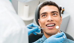 A male patient prepares to have his teeth and soft tissues examined 