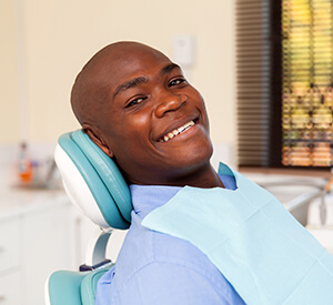 Man leaning back on dental chair smiling