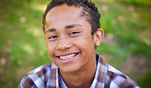 young boy cocking a grin