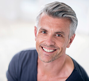 Elderly gentleman looking up smiling