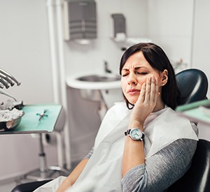 Woman with toothache at dentist's office