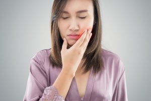 woman frowning from tooth pain