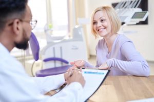 a young woman talking to her dentist