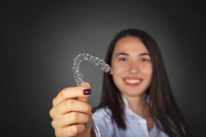 woman holding Invisalign