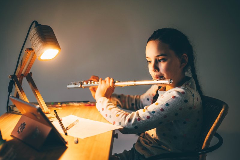 Young girl playing the flute