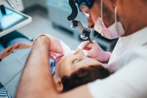 Dentist working on teenager.